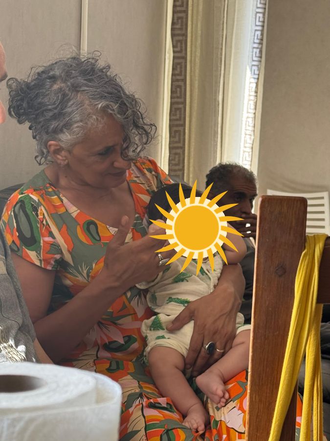 Jamila chez elle, un bébé dans les bras
